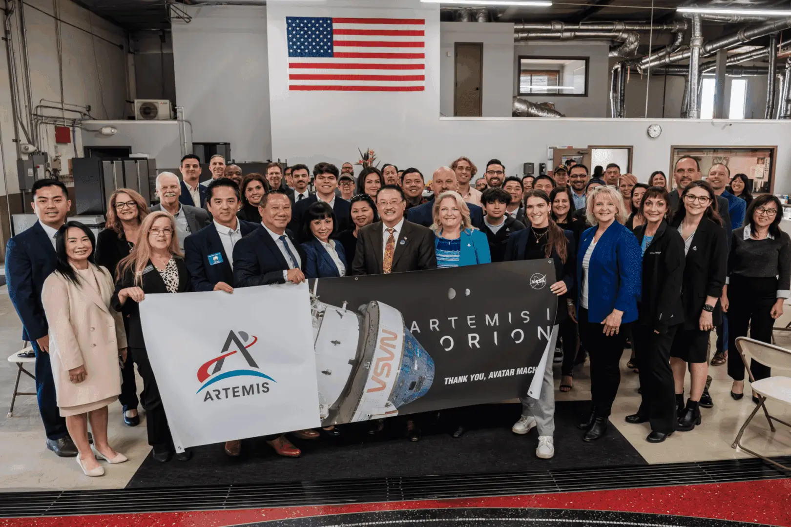 Team posing with Artemis Orion mission banner